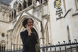 Woman talking on a mobile phone outside the Royal Court of Justice