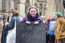 Disabled girls at an equality march, holding a sign saying 'I've got rights!'