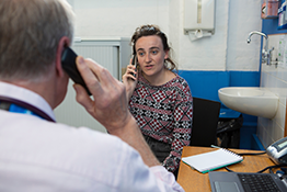 Doctor and patient using a translation service via telephone